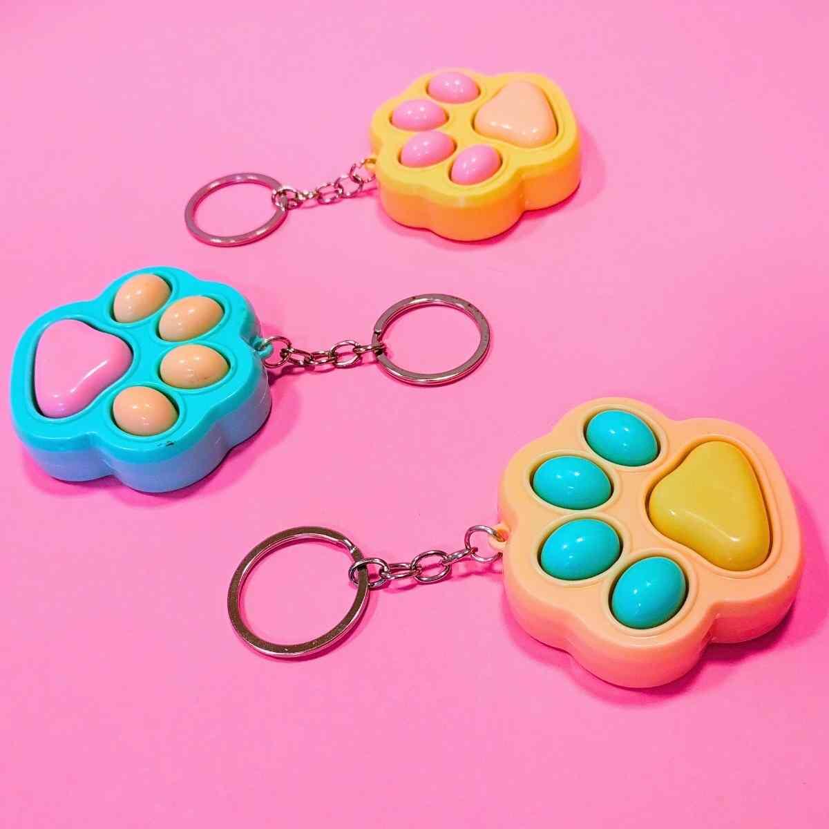 Juego Huellitas pop it y llavero